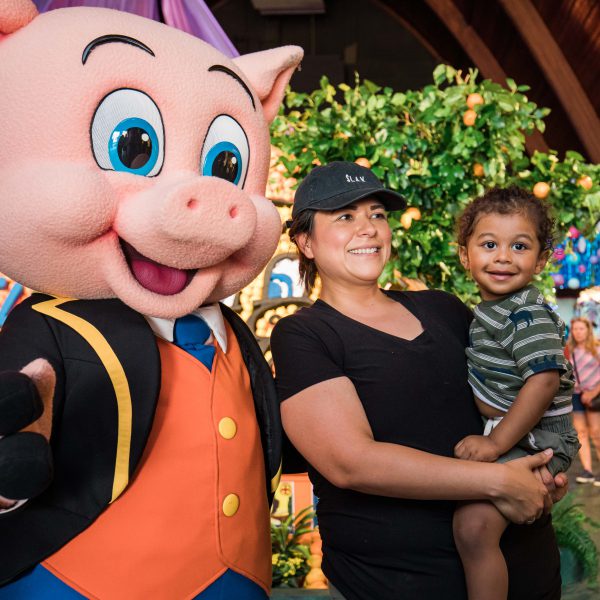 Child and Parent Smiling with Thummer the Pig