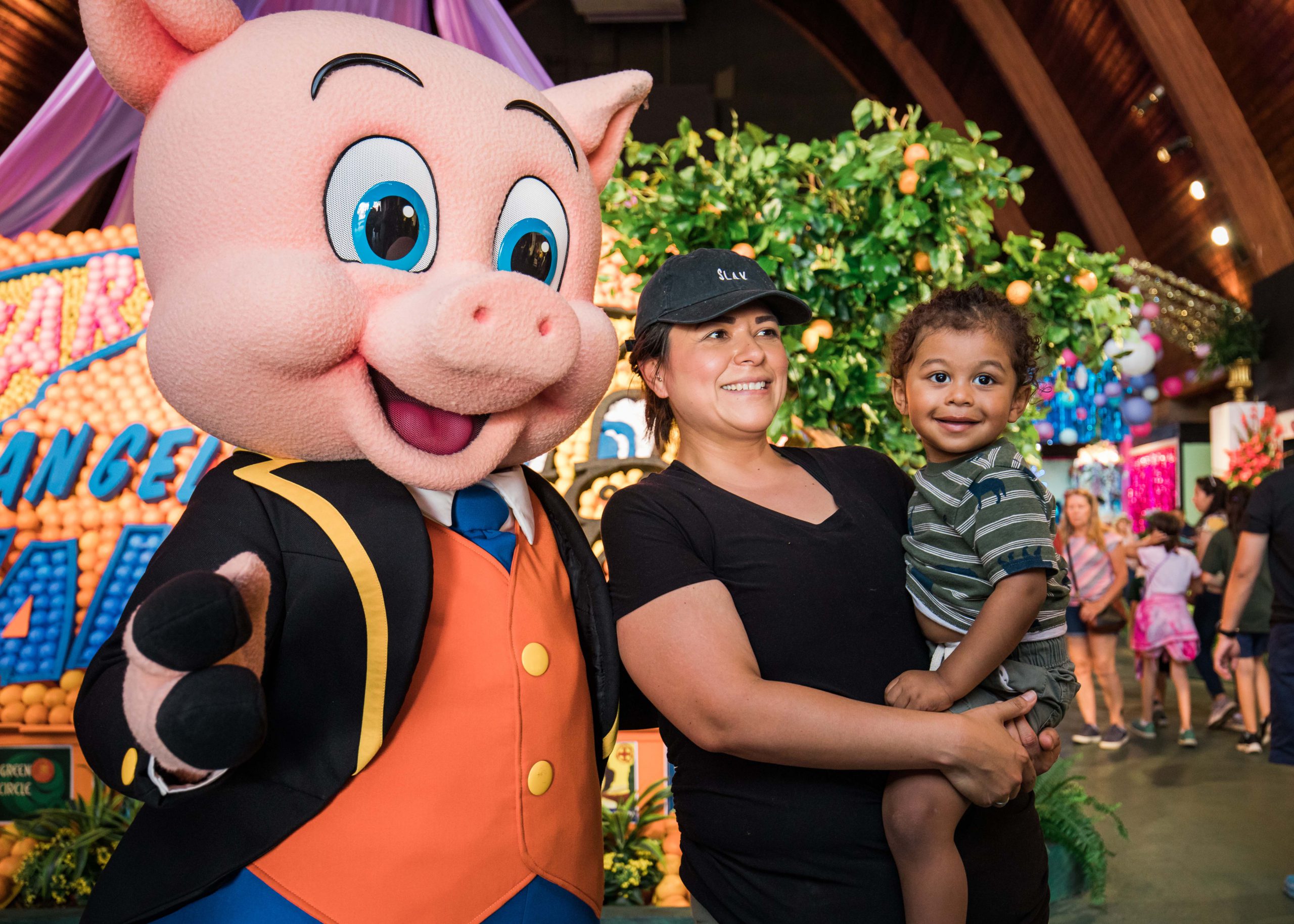 Child and Parent Smiling with Thummer the Pig